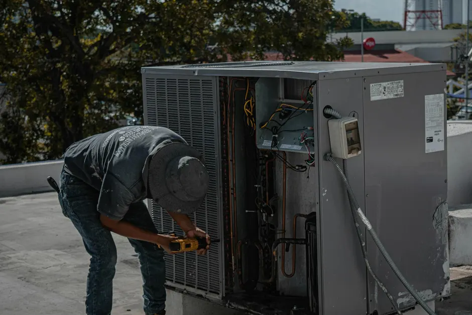 Technician diagnosing an air conditioner that is running but not cooling
