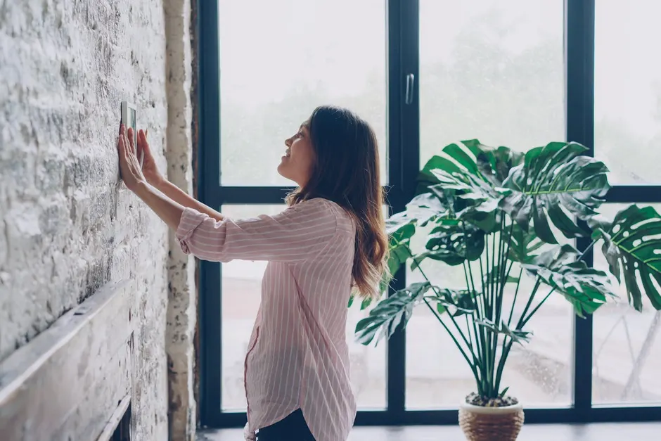 Homeowner adjusting a thermostat to troubleshoot an AC that is not cooling